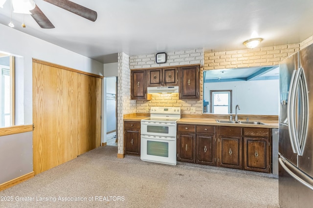 1802 Rockdale Ave, Lansing, MI 48917 - kitchen featuring double oven range, a sink, under cabinet range hood, stainless steel fridge with ice dispenser, and a ceiling fan