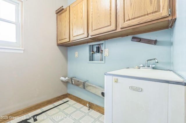 1802 Rockdale Ave, Lansing, MI 48917 - laundry room with cabinet space, light flooring, baseboards, and hookup for a washing machine