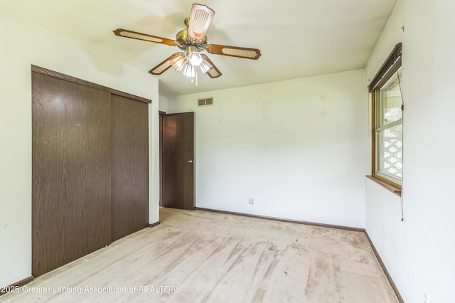 1802 Rockdale Ave, Lansing, MI 48917 - unfurnished bedroom featuring light carpet, a closet, a ceiling fan, and baseboards