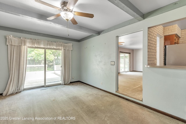 1802 Rockdale Ave, Lansing, MI 48917 - empty room with beamed ceiling, carpet floors, ceiling fan, and baseboards