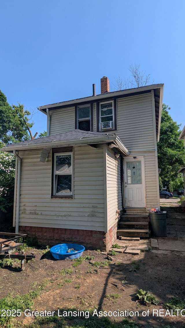 1515 Prospect St, Lansing, MI 48912 - back of property featuring entry steps and a chimney