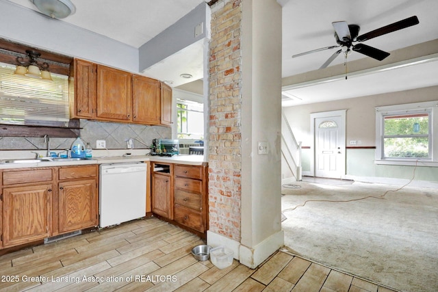 1515 Prospect St, Lansing, MI 48912 - kitchen with dishwasher, light countertops, wood tiled floors, backsplash, and ceiling fan