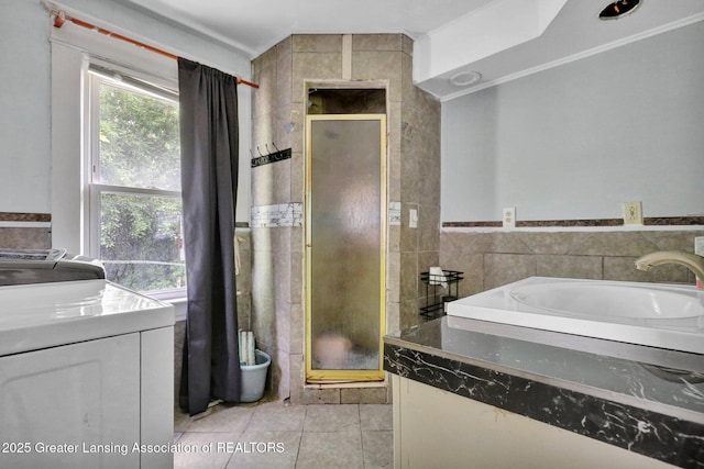 1515 Prospect St, Lansing, MI 48912 - bathroom with washer / dryer, a shower stall, tile patterned floors, tile walls, and vanity
