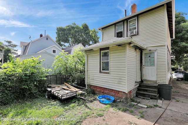 1515 Prospect St, Lansing, MI 48912 - back of house featuring entry steps and a chimney