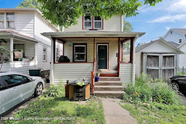 1515 Prospect St, Lansing, MI 48912 - american foursquare style home with a storage shed and covered porch
