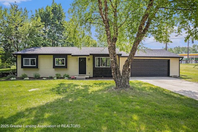 1808 Cadillac Ave, Lansing, MI 48917 - ranch-style house with a garage, driveway, and a front yard