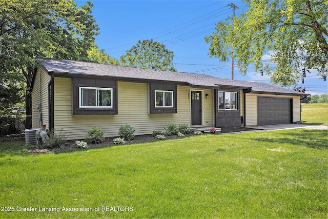 1808 Cadillac Ave, Lansing, MI 48917 - single story home featuring an attached garage, a front lawn, cooling unit, driveway, and roof with shingles