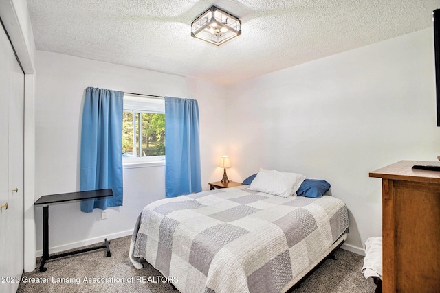 1808 Cadillac Ave, Lansing, MI 48917 - carpeted bedroom with baseboards, a textured ceiling, and a closet