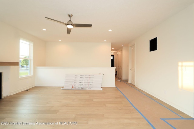 629 Aquila Dr, East Lansing, MI 48823 - empty room featuring light wood finished floors, recessed lighting, ceiling fan, a fireplace, and baseboards