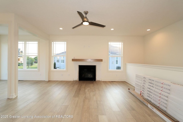 629 Aquila Dr, East Lansing, MI 48823 - unfurnished living room with a fireplace, light wood finished floors, recessed lighting, ceiling fan, and baseboards
