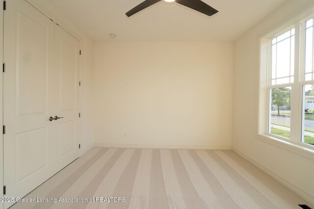 629 Aquila Dr, East Lansing, MI 48823 - unfurnished room featuring light carpet, baseboards, and ceiling fan
