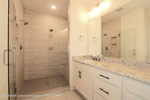629 Aquila Dr, East Lansing, MI 48823 - bathroom with vanity, a stall shower, recessed lighting, and tile patterned flooring