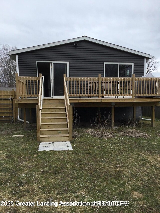 4615 Hughes Rd, Lansing, MI 48910 - back of house featuring a deck, stairway, and a yard