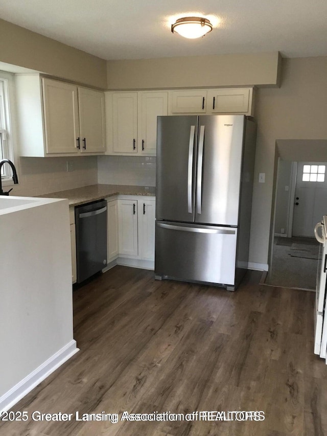 4615 Hughes Rd, Lansing, MI 48910 - kitchen with appliances with stainless steel finishes, white cabinets, dark wood-type flooring, and baseboards