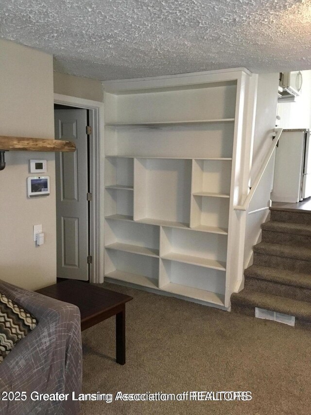 4615 Hughes Rd, Lansing, MI 48910 - unfurnished bedroom featuring carpet and a textured ceiling