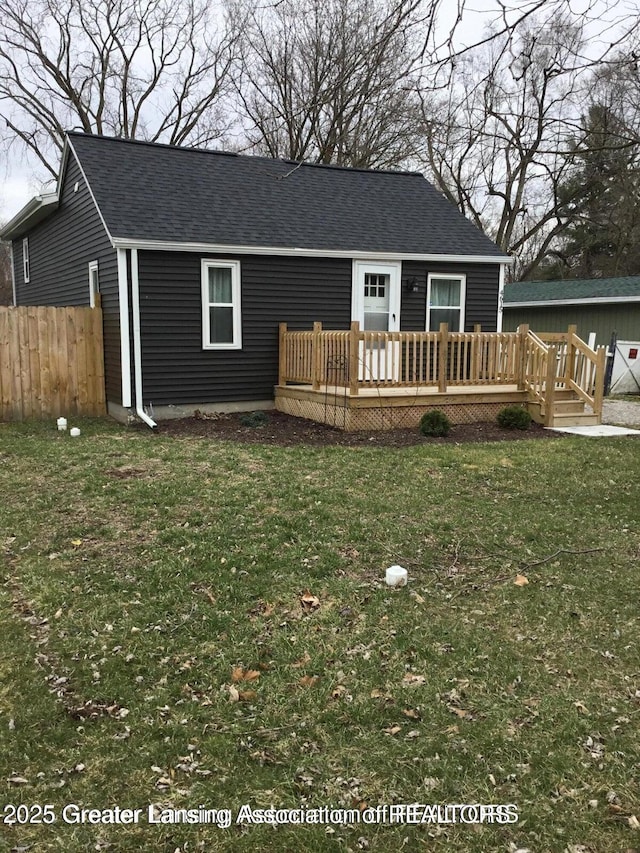 4615 Hughes Rd, Lansing, MI 48910 - rear view of house featuring a deck and a shingled roof