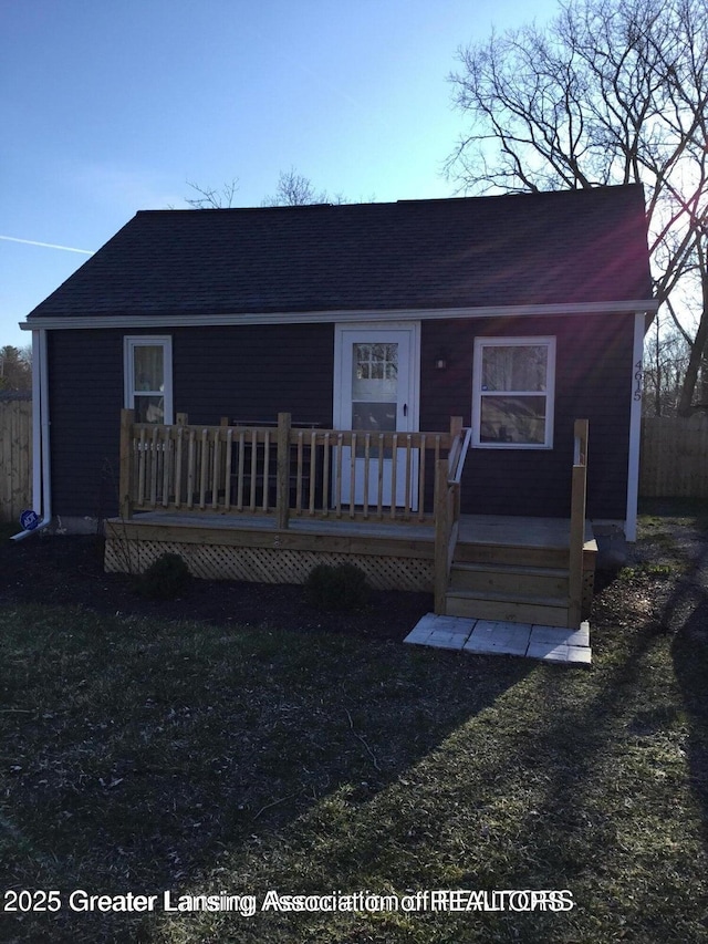 4615 Hughes Rd, Lansing, MI 48910 - view of front of home featuring a deck and roof with shingles