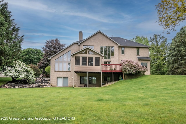 1120 Nautical Dr, Okemos, MI 48864 - back of property with a sunroom, brick siding, a chimney, a lawn, and a deck