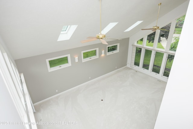 1120 Nautical Dr, Okemos, MI 48864 - carpeted spare room with a skylight, lofted ceiling, healthy amount of natural light, a ceiling fan, and baseboards