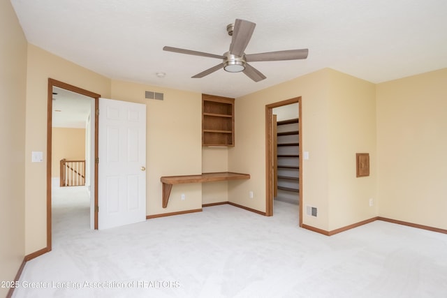 1120 Nautical Dr, Okemos, MI 48864 - unfurnished bedroom featuring carpet flooring, a spacious closet, baseboards, and a ceiling fan