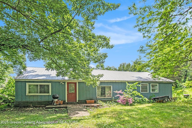 3770 E Frost Rd, Webberville, MI 48892 - view of front of property featuring metal roof and a front lawn
