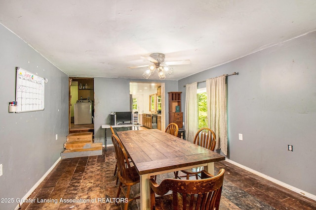 3770 E Frost Rd, Webberville, MI 48892 - dining area with baseboards, ceiling fan, washer / clothes dryer, and stairs