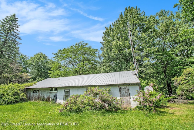 3770 E Frost Rd, Webberville, MI 48892 - back of house featuring metal roof and concrete block siding