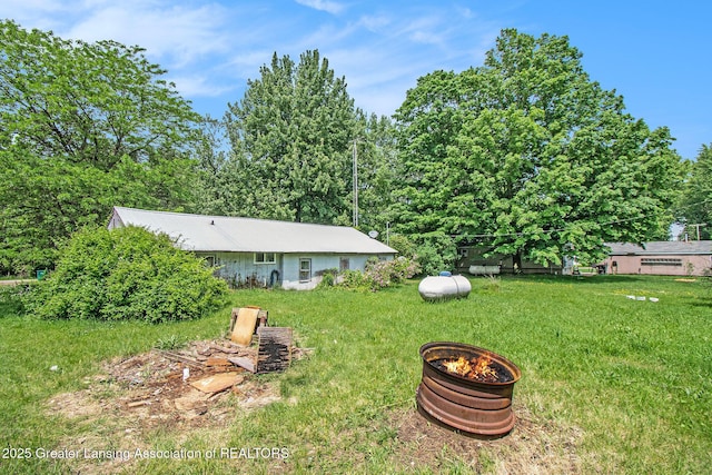 3770 E Frost Rd, Webberville, MI 48892 - view of green lawn with an outdoor fire pit