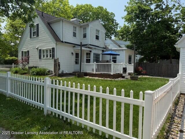 942 W Grand River Ave, East Lansing, MI 48823 - view of front of house featuring a wooden deck and a fenced backyard