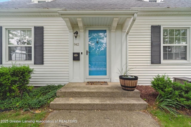 942 W Grand River Ave, East Lansing, MI 48823 - property entrance featuring a shingled roof