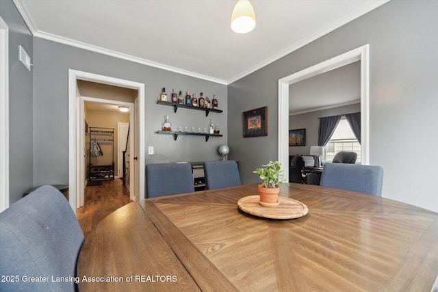 942 W Grand River Ave, East Lansing, MI 48823 - dining room featuring ornamental molding, wood finished floors, and a dry bar