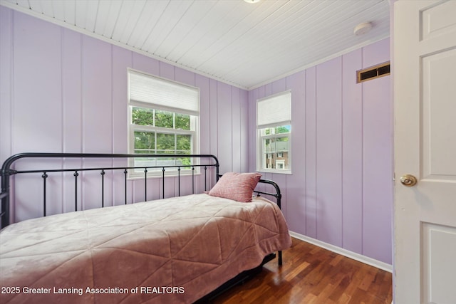942 W Grand River Ave, East Lansing, MI 48823 - bedroom featuring wood finished floors, a decorative wall, and wooden ceiling