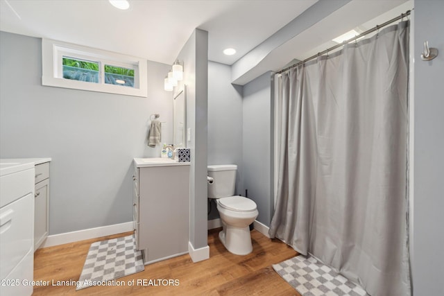 942 W Grand River Ave, East Lansing, MI 48823 - full bath featuring vanity, wood finished floors, recessed lighting, and a shower with shower curtain