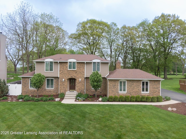 6108 Skyline Dr, East Lansing, MI 48823 - traditional-style house with a chimney and brick siding