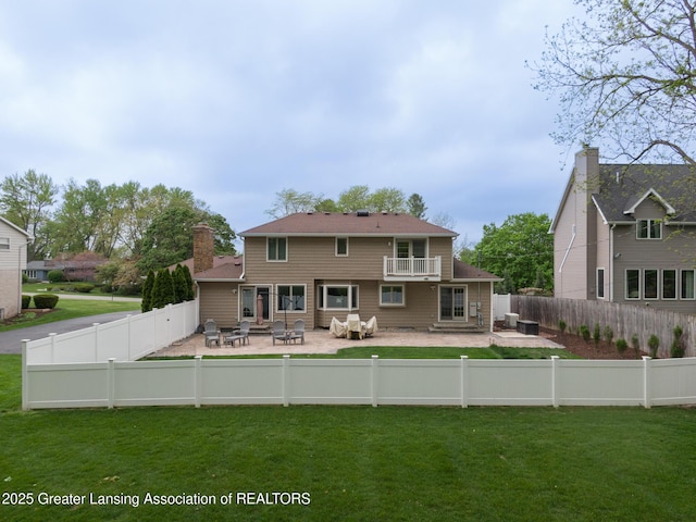 6108 Skyline Dr, East Lansing, MI 48823 - rear view of house featuring a fire pit, a patio, and a balcony