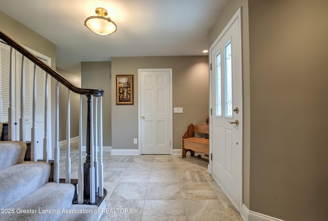 6108 Skyline Dr, East Lansing, MI 48823 - foyer featuring stairway and baseboards