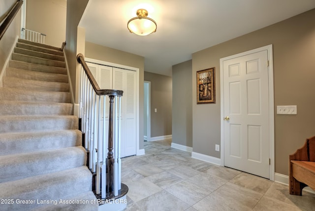 6108 Skyline Dr, East Lansing, MI 48823 - stairway featuring baseboards