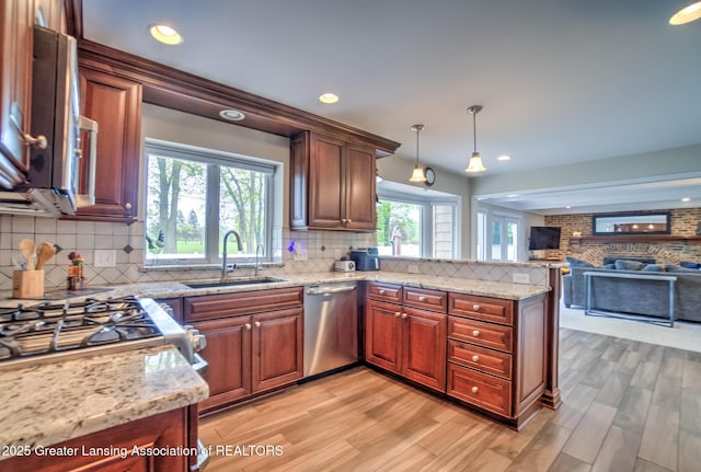 6108 Skyline Dr, East Lansing, MI 48823 - kitchen with a sink, dishwasher, a peninsula, decorative backsplash, and recessed lighting