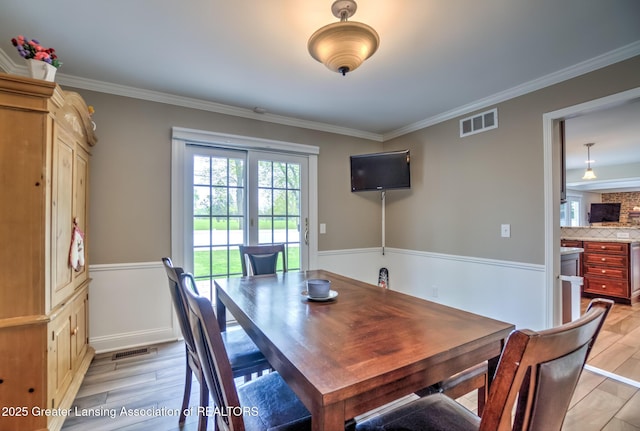 6108 Skyline Dr, East Lansing, MI 48823 - dining space with crown molding and light wood-type flooring