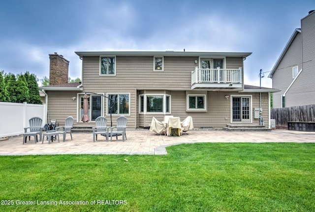 6108 Skyline Dr, East Lansing, MI 48823 - rear view of property featuring a balcony, a chimney, a patio, and entry steps