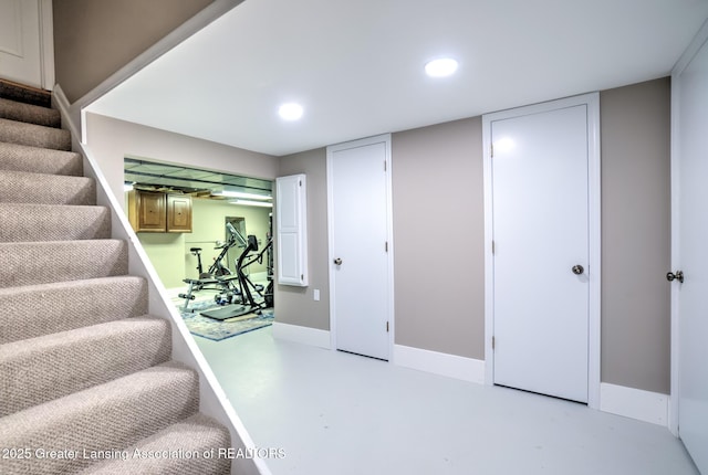 6108 Skyline Dr, East Lansing, MI 48823 - staircase featuring recessed lighting and concrete floors