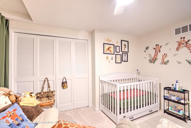 6108 Skyline Dr, East Lansing, MI 48823 - bedroom featuring a closet, carpet, a crib, and a ceiling fan