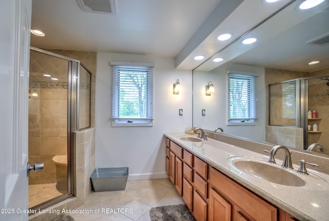 6108 Skyline Dr, East Lansing, MI 48823 - full bathroom featuring plenty of natural light, tile patterned flooring, double vanity, a shower stall, and recessed lighting