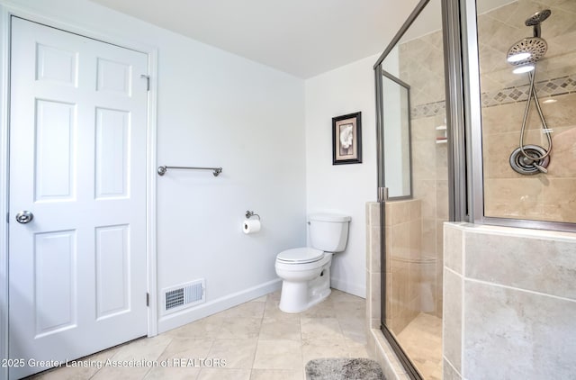 6108 Skyline Dr, East Lansing, MI 48823 - bathroom featuring baseboards, toilet, a stall shower, and tile patterned flooring