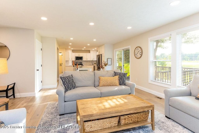 5871 Green Rd, Haslett, MI 48840 - living room with recessed lighting, plenty of natural light, and light wood-style flooring
