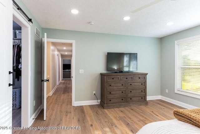 5871 Green Rd, Haslett, MI 48840 - living area with light wood-type flooring, a barn door, and recessed lighting