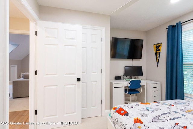 5871 Green Rd, Haslett, MI 48840 - bedroom featuring multiple windows, light wood-style flooring, and a desk