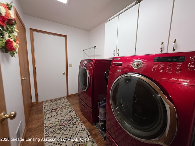 2380 S Waverly Rd, Eaton Rapids, MI 48827 - laundry area featuring washing machine and clothes dryer, wood finished floors, cabinet space, and baseboards