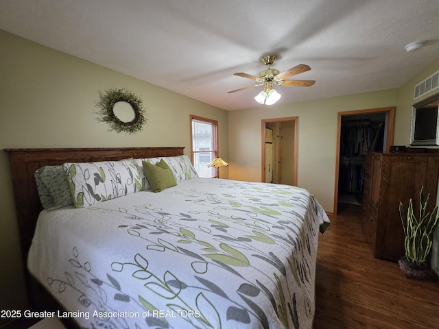 2380 S Waverly Rd, Eaton Rapids, MI 48827 - bedroom featuring dark wood-type flooring, ceiling fan, and a spacious closet