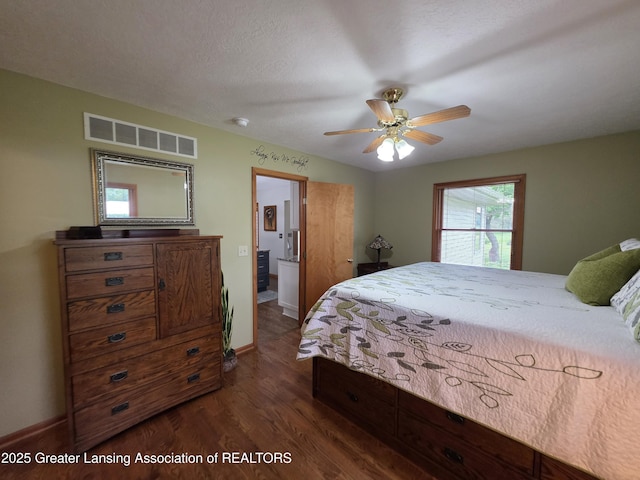 2380 S Waverly Rd, Eaton Rapids, MI 48827 - bedroom featuring dark wood-style flooring, baseboards, and ensuite bath